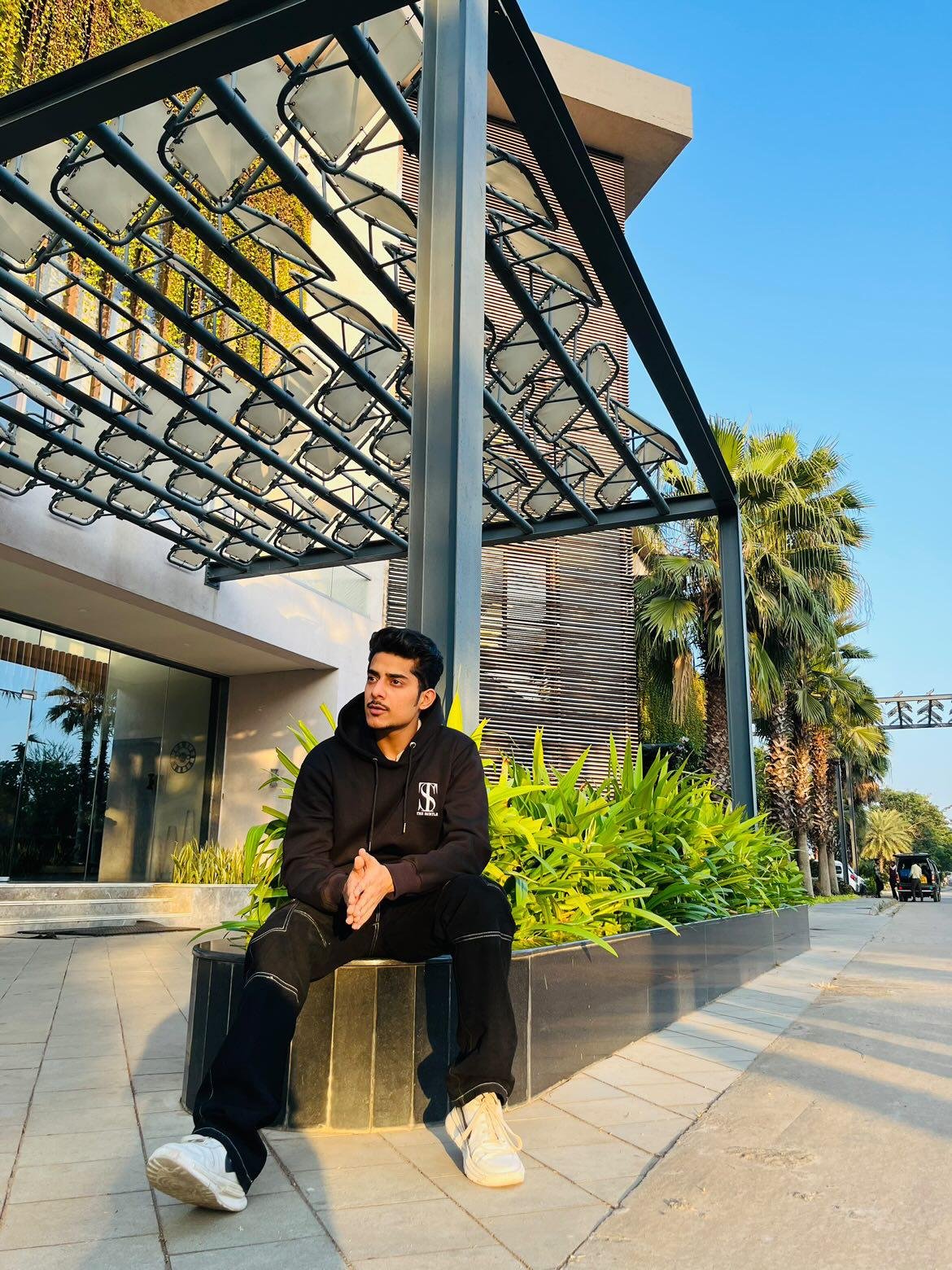 Instagram influencer achin wearing the subtle black hoodie